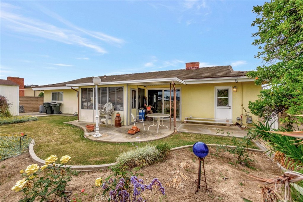 1602 Minorca Drive Costa Mesa, CA 92626 - Photo 28 of 33 a view of a house with backyard sitting area and garden