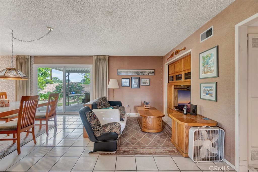 1602 Minorca Drive Costa Mesa, CA 92626 - Photo 8 of 33 a living room with furniture a flat screen tv and large windows