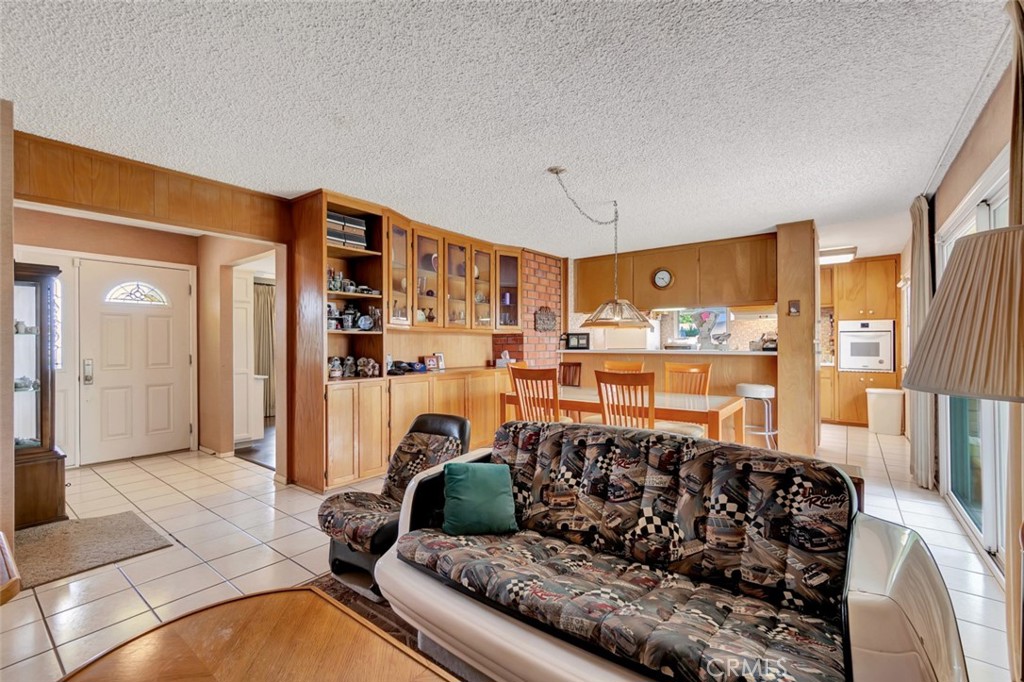 1602 Minorca Drive Costa Mesa, CA 92626 - Photo 9 of 33 a living room with furniture and a floor to ceiling window