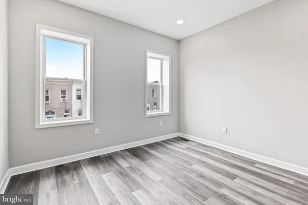 a view of room with window and hardwood floor