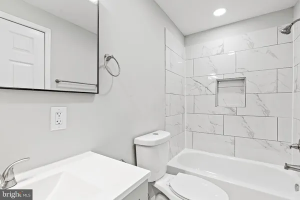 a bathroom with a toilet a sink and bathtub