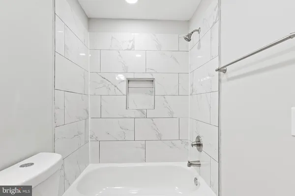 a bathroom with a bathtub and toilet