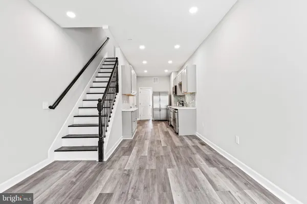 a view of entryway and hall with wooden floor
