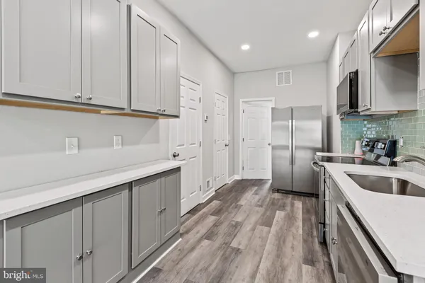 a kitchen with cabinets and stainless steel appliances