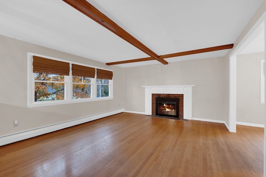 16 Hadley Path West Brookfield, MA 01585 - Photo 4 of 30 a view of an empty room with wooden floor fireplace and a window