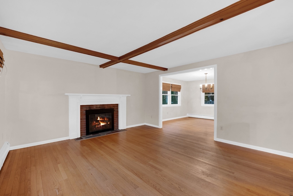 16 Hadley Path West Brookfield, MA 01585 - Photo 6 of 30 a view of an empty room with a fireplace and a window