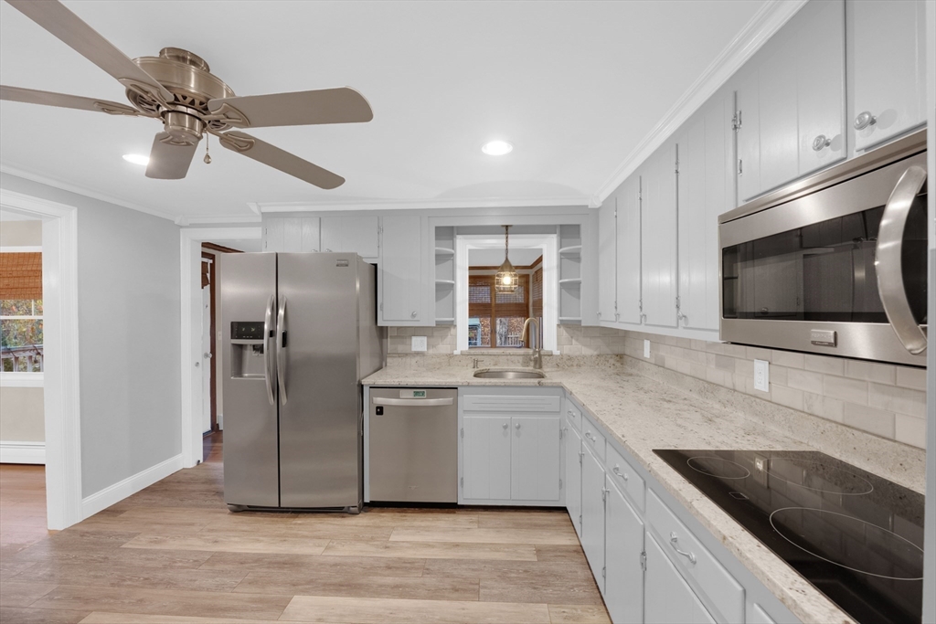 16 Hadley Path West Brookfield, MA 01585 - Photo 8 of 30 a kitchen with stainless steel appliances granite countertop a sink a microwave a refrigerator and cabinets