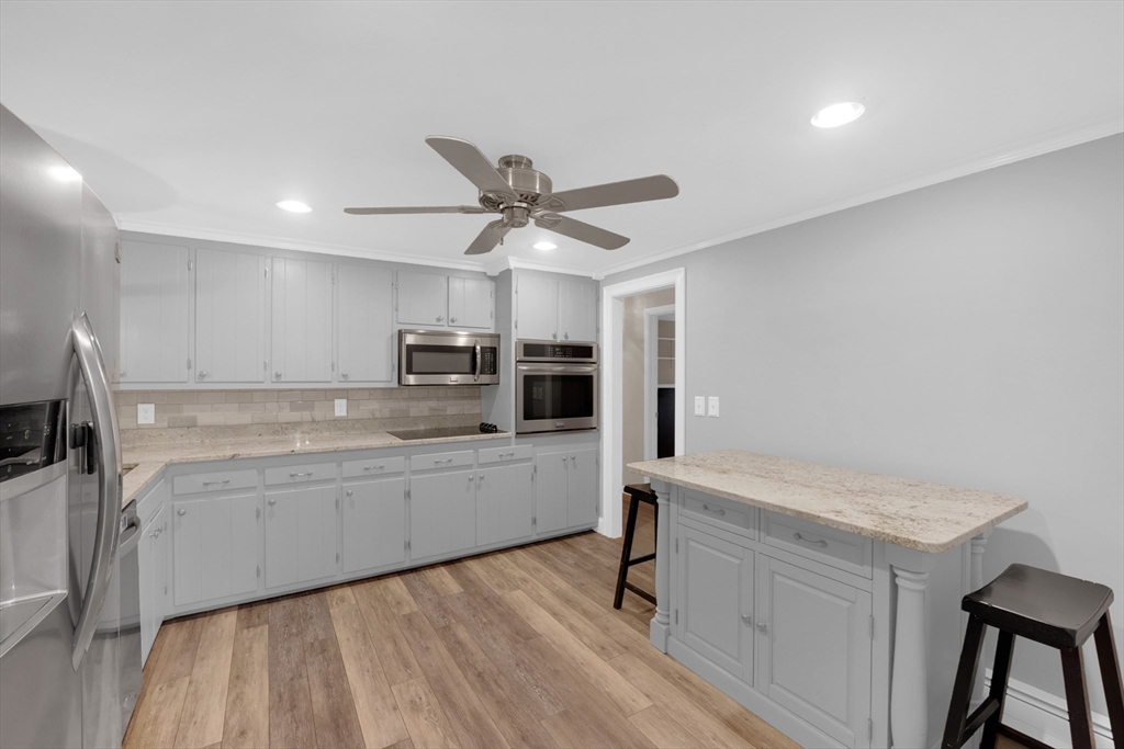 16 Hadley Path West Brookfield, MA 01585 - Photo 9 of 30 a kitchen with stainless steel appliances a sink cabinets and wooden floor