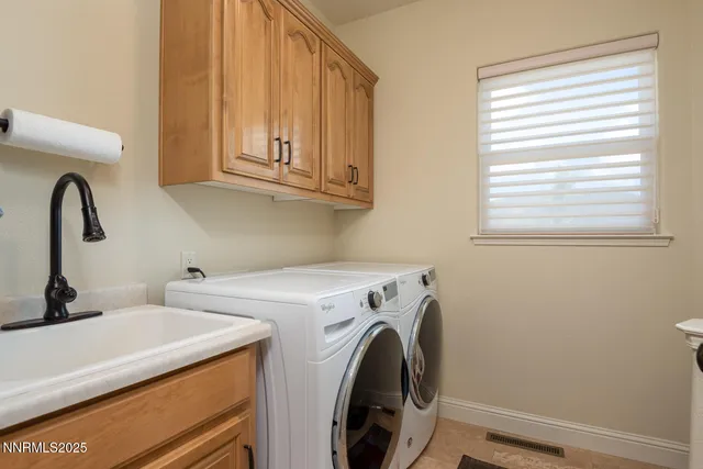 a spacious bedroom with a bed a couch and a chandelier