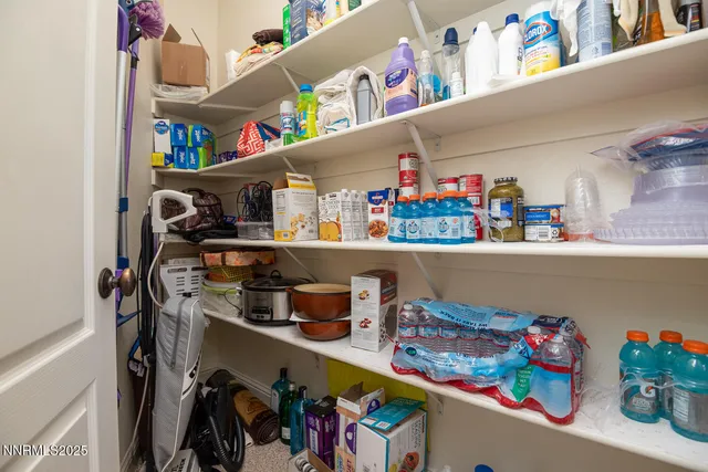 a bed sitting in a spacious bedroom next to a window