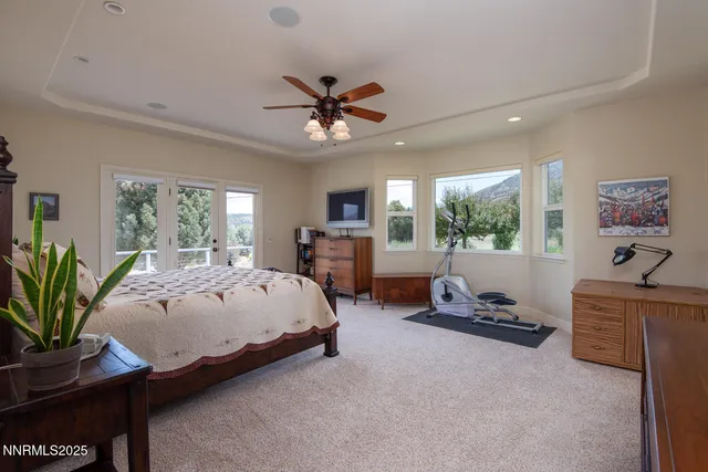 a bedroom with a bed and a large window
