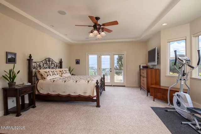 a bedroom with a bed and glass windows