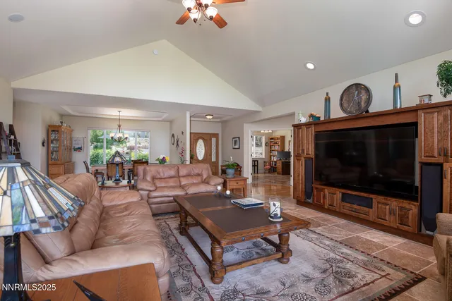 a dining room with furniture a chandelier and a rug