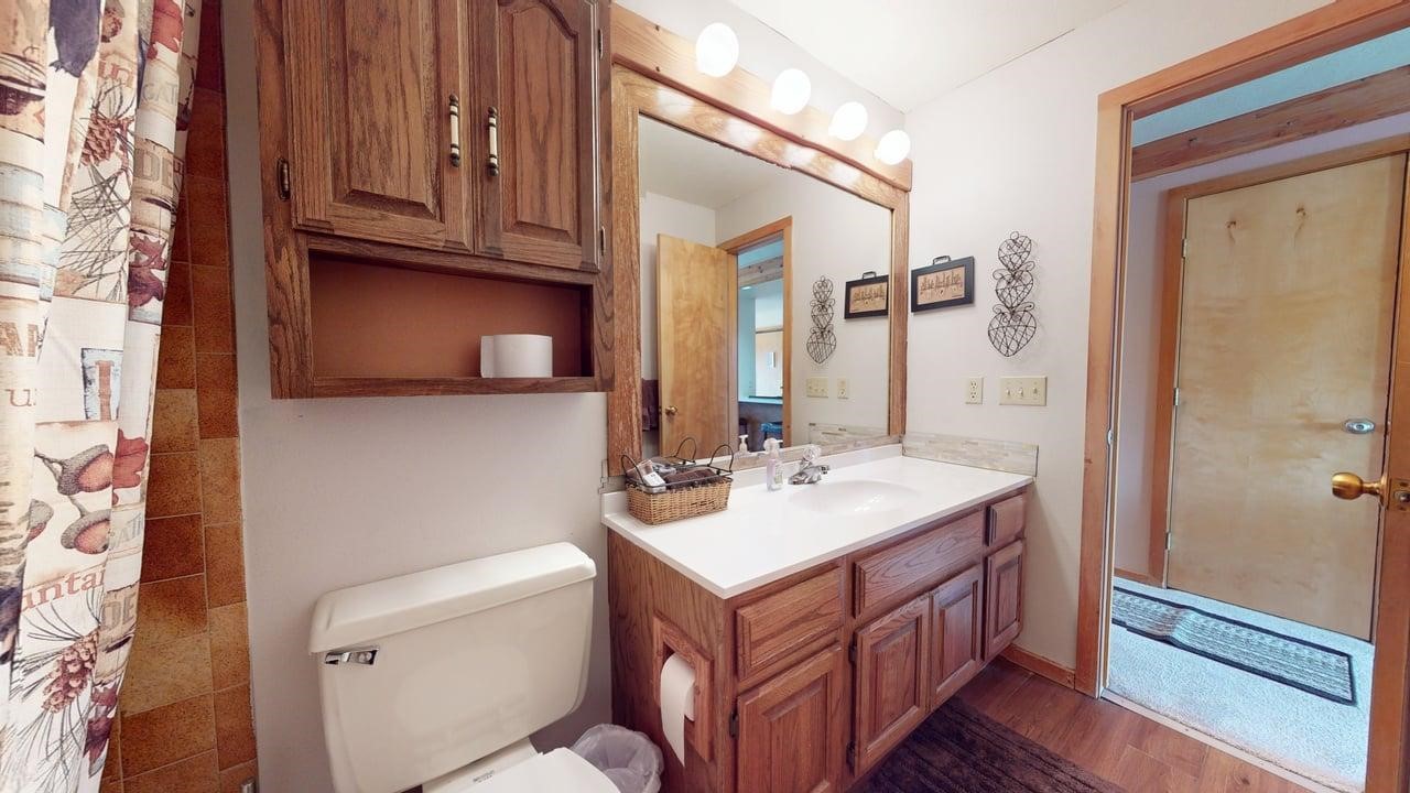 91200 Ryan Gulch Road, Unit 213 Silverthorne, CO 80498 - Photo 27 of 33 a bathroom with a sink a toilet and shower