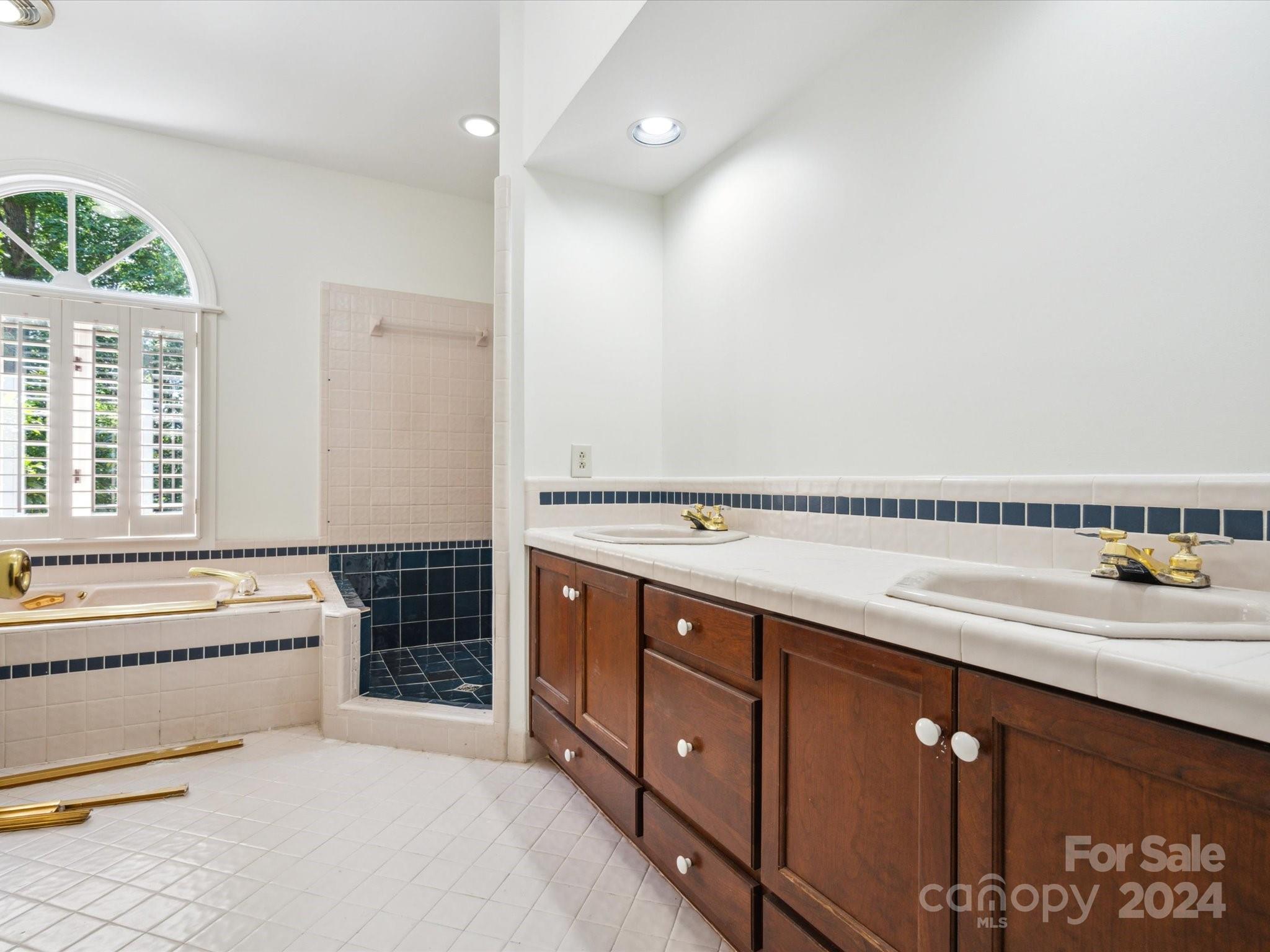 1101 Sydney Drive Charlotte, NC 28270 - Photo 12 of 46 a spacious bathroom with a tub double vanity and a sink