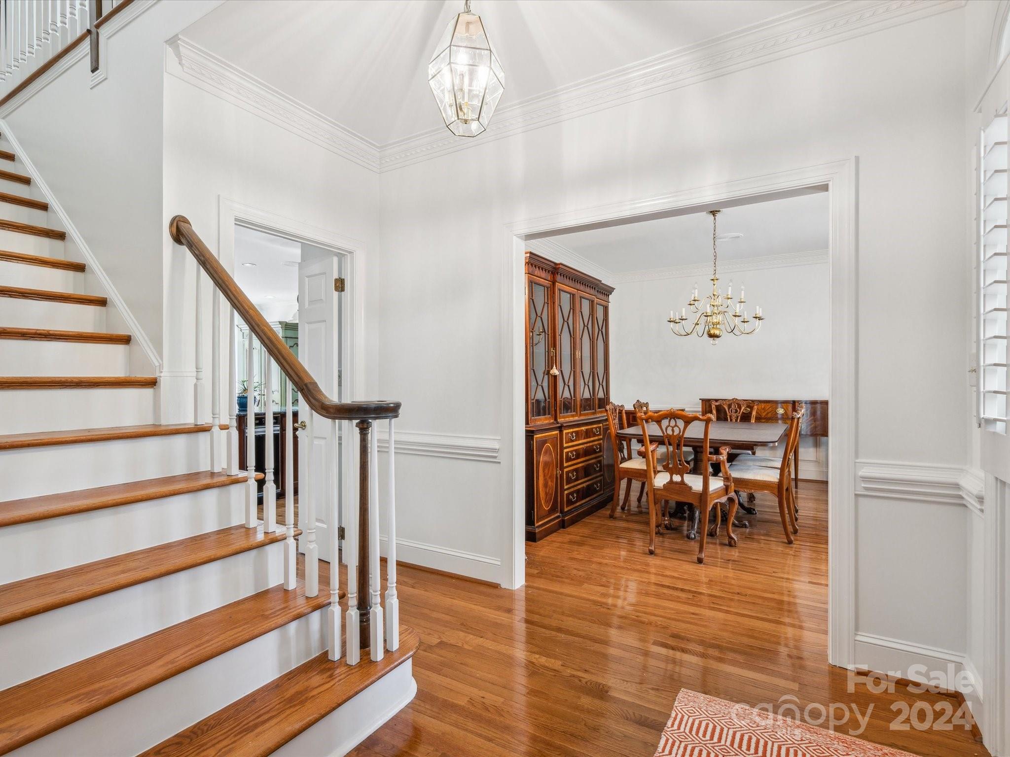 1101 Sydney Drive Charlotte, NC 28270 - Photo 3 of 46 a view of a dining room with furniture a chandelier and wooden floor