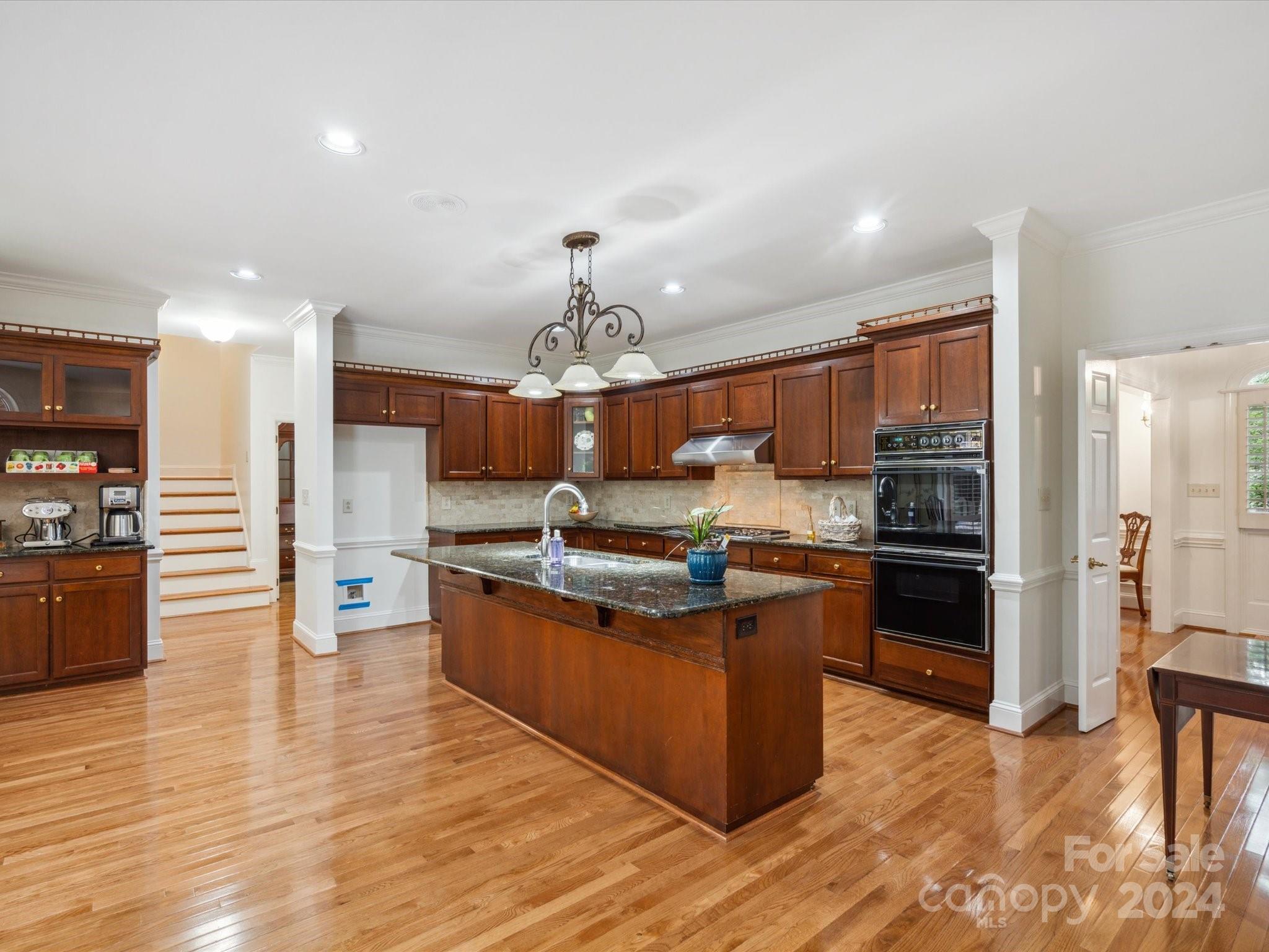 1101 Sydney Drive Charlotte, NC 28270 - Photo 5 of 46 a large kitchen with stainless steel appliances kitchen island granite countertop a large counter top and wooden floors