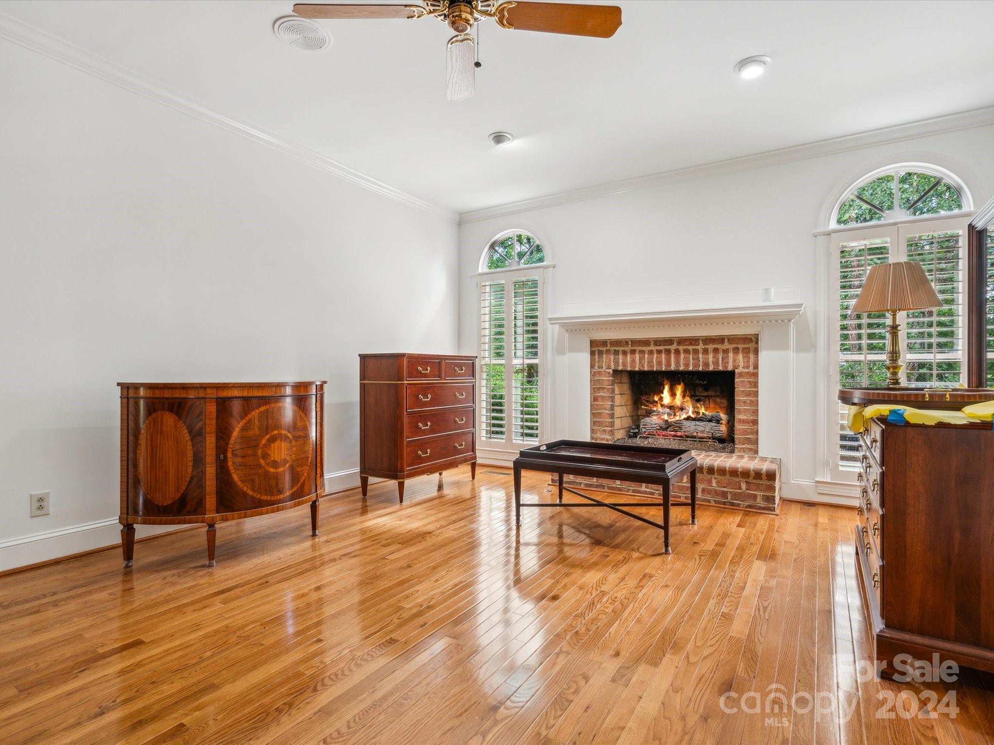 1101 Sydney Drive Charlotte, NC 28270 - Photo 9 of 46 a living room with furniture a fireplace and a floor to ceiling window