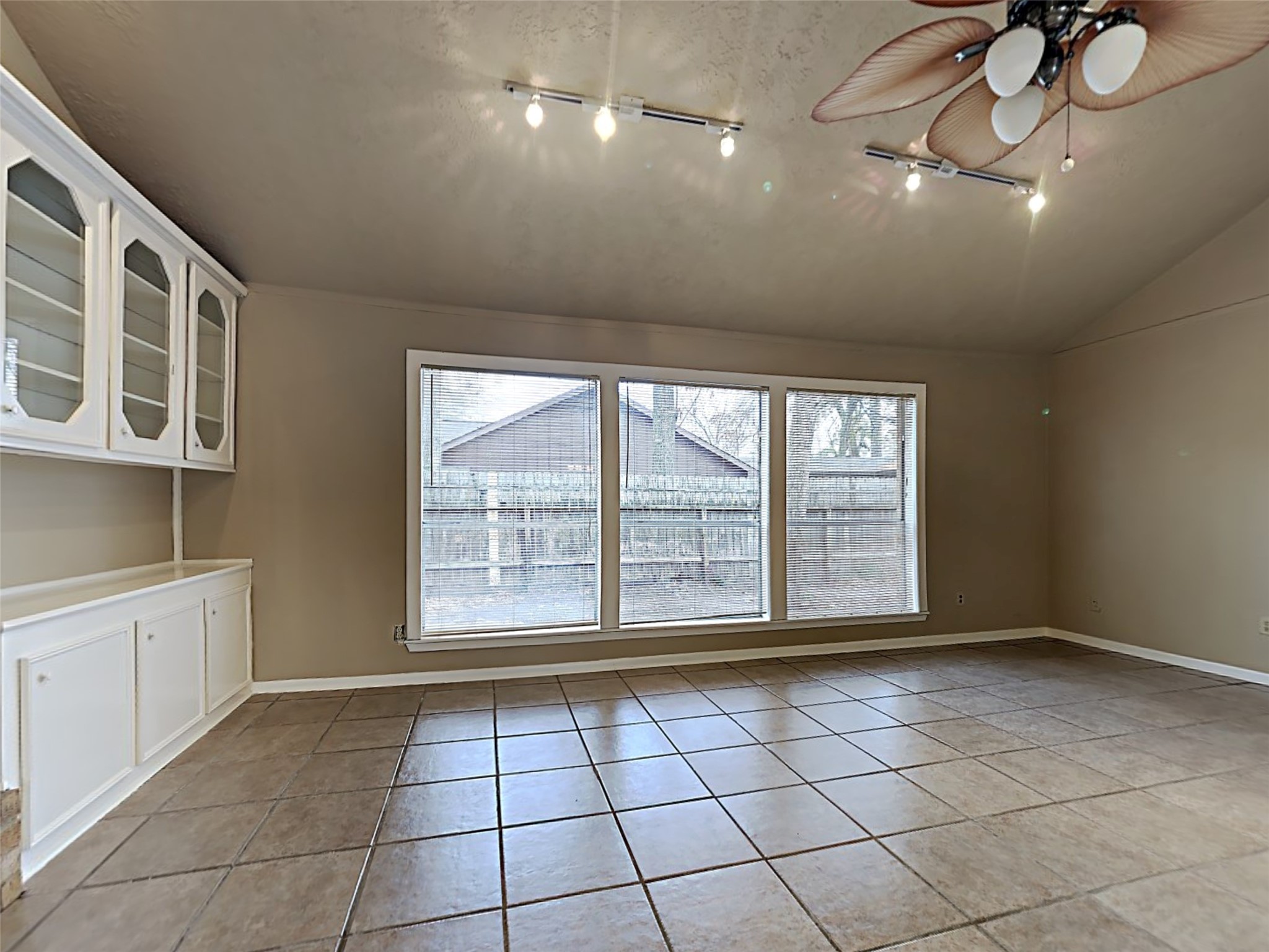 603 Blue Ridge Drive Shenandoah, TX 77381 - Photo 11 of 17 a view of an empty room with a window and kitchen view