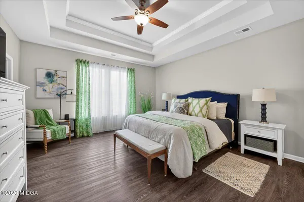 a bedroom with a bed and a chandelier