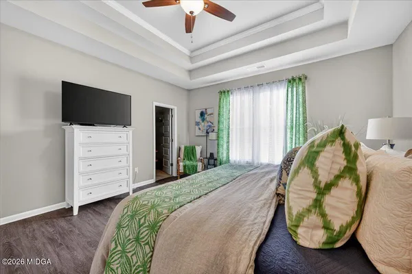 a bedroom with a bed and a television