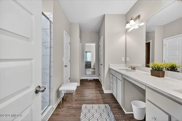 a bathroom with a double vanity sink and a mirror