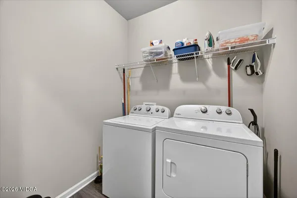 a view of storage and utility room with dryer and washer