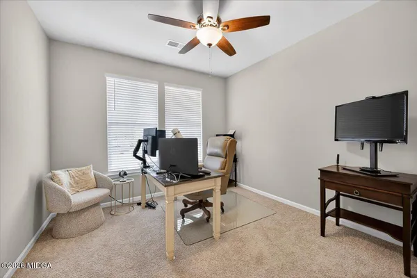 a view of a workspace with a window and a flat screen tv