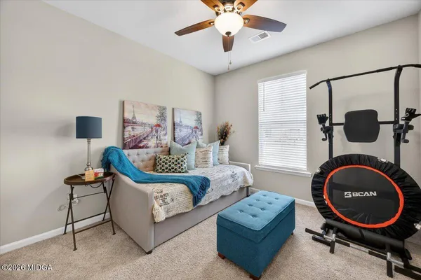 a living room with furniture a rug and a mirror