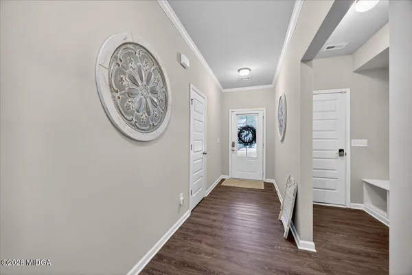 a view of a hallway with wooden floor