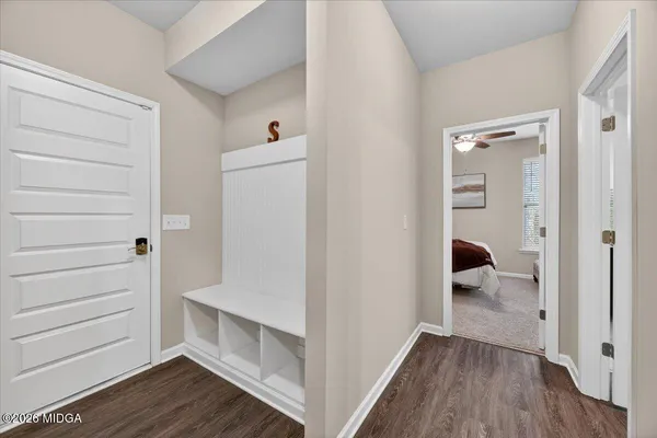 a view of walk in closet with wooden floor