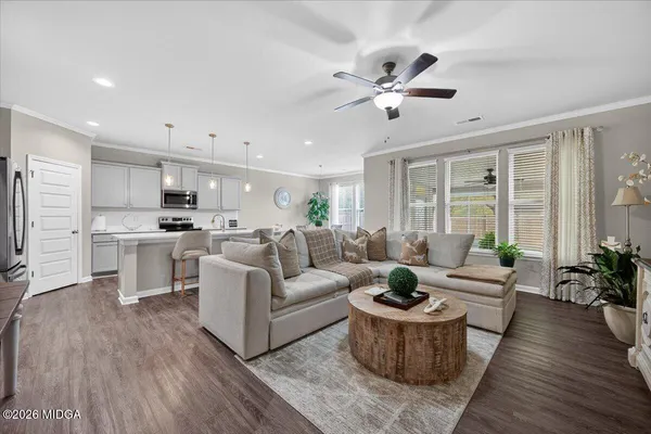 a living room with furniture and white walls