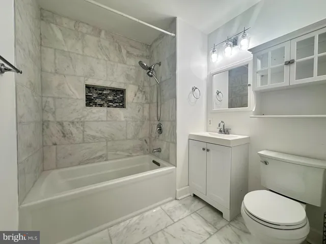 a bathroom with a toilet a sink and bathtub