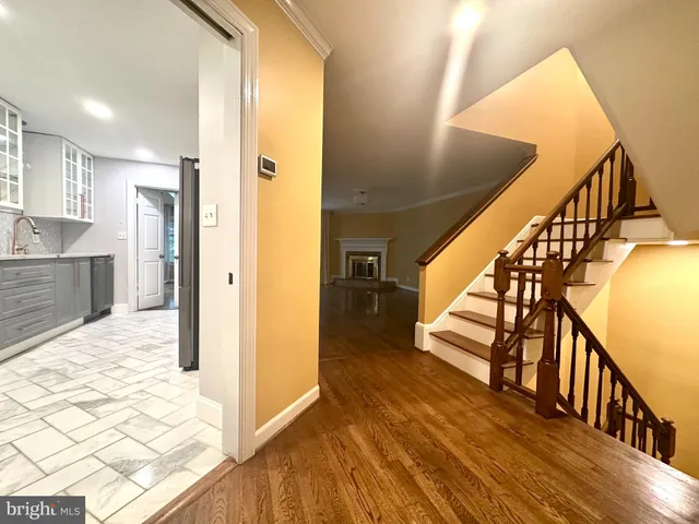 a view of entryway and hall with wooden floor