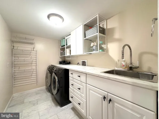 a bathroom with a granite countertop sink and mirror
