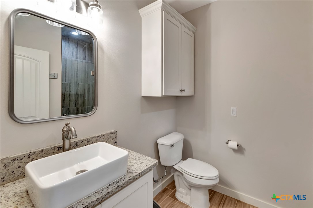 52 Coastal Oaks Loop Port O'Connor, TX 77982 - Photo 19 of 23 a bathroom with a sink and a toilet