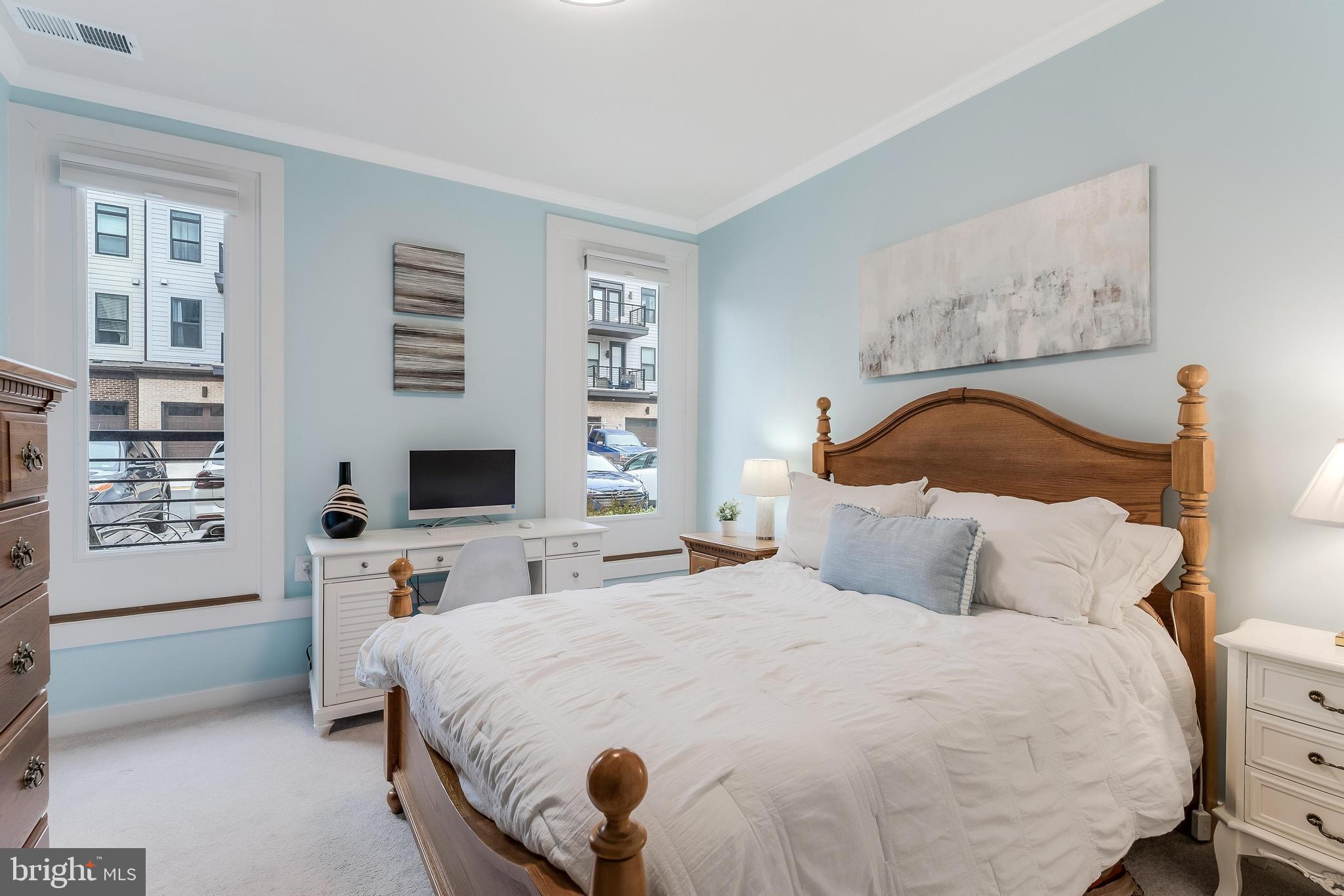 1675 Bandit Loop, Unit 105B Reston, VA 20190 - Photo 12 of 27 a bedroom with a bed a mirror and a window
