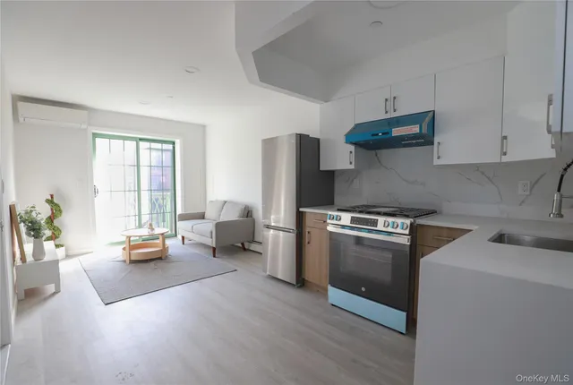 a kitchen with stainless steel appliances granite countertop a refrigerator stove and sink