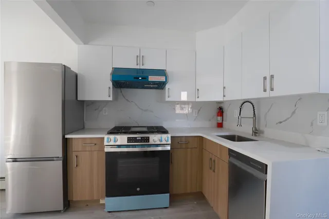 a kitchen with a stove and a refrigerator