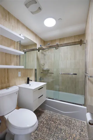a bathroom with a toilet a sink and shower
