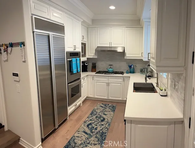 a kitchen with kitchen island granite countertop a sink stove and cabinets