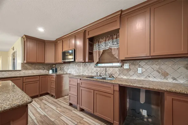 a kitchen with a sink and cabinets
