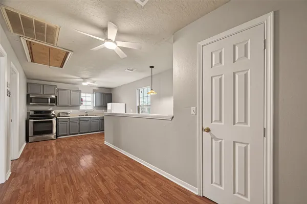 a kitchen with stainless steel appliances granite countertop a refrigerator and a stove top oven