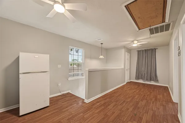 a view of empty room with wooden floor