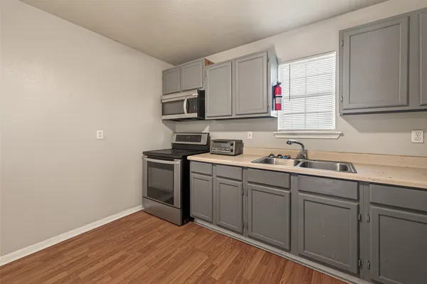 a kitchen with sink cabinets and microwave