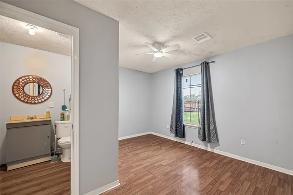 an empty room with wooden floor and a window