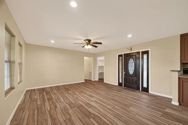 wooden floor in an empty room with a window