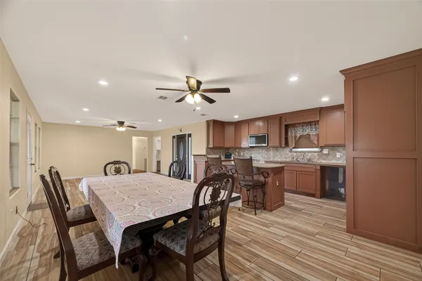 a view of a dining room with furniture and wooden floor