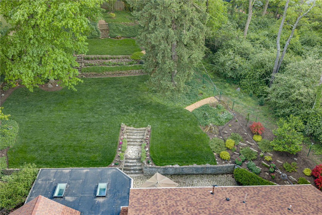 156 West Hadley Road Dayton, OH 45419 - Photo 62 of 71 This lush yard offers tiered landscaping and mature trees, creating a serene outdoor sanctuary.
