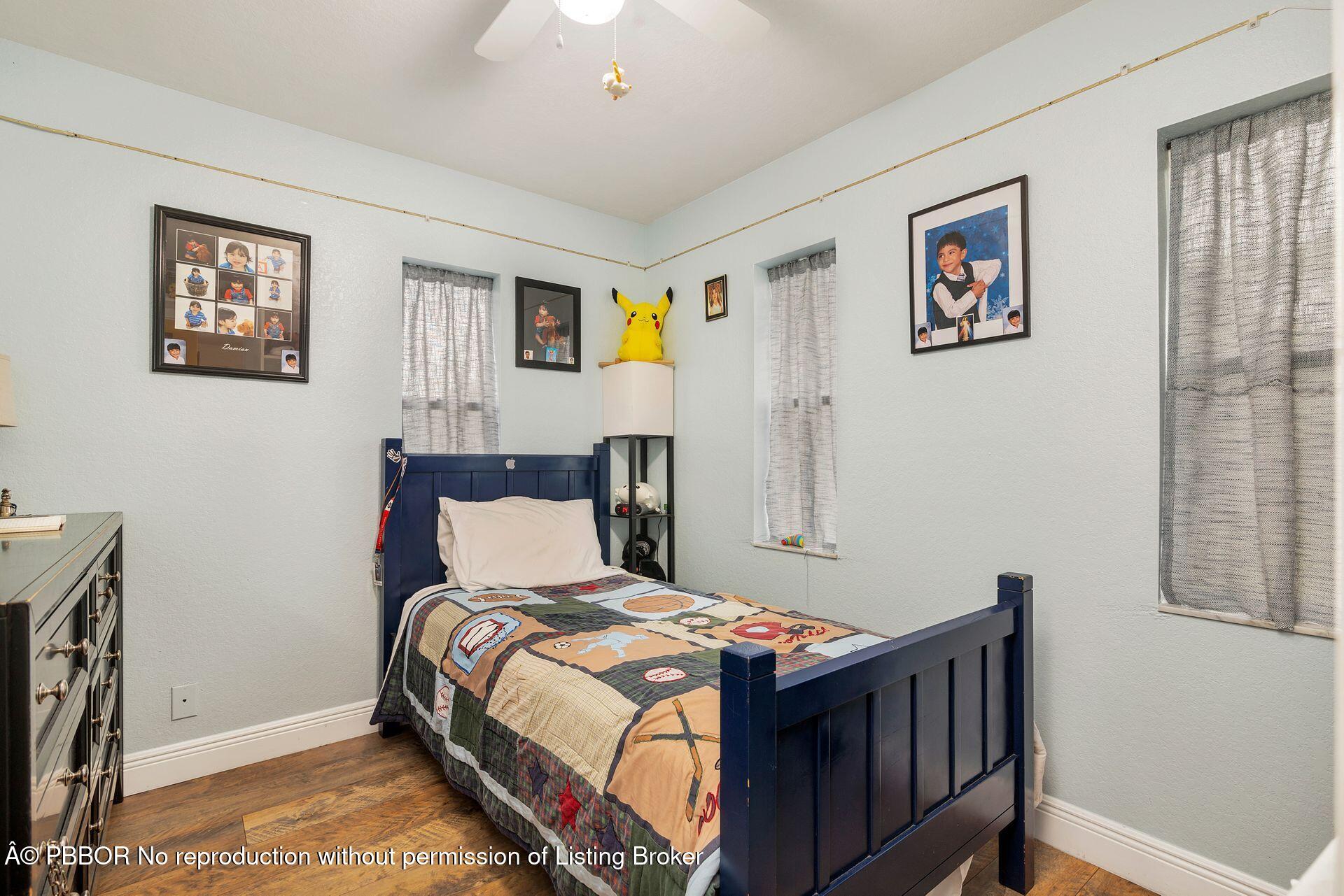2770 E Road Loxahatchee, FL 33470 - Photo 34 of 51 a bedroom with a bed and a window
